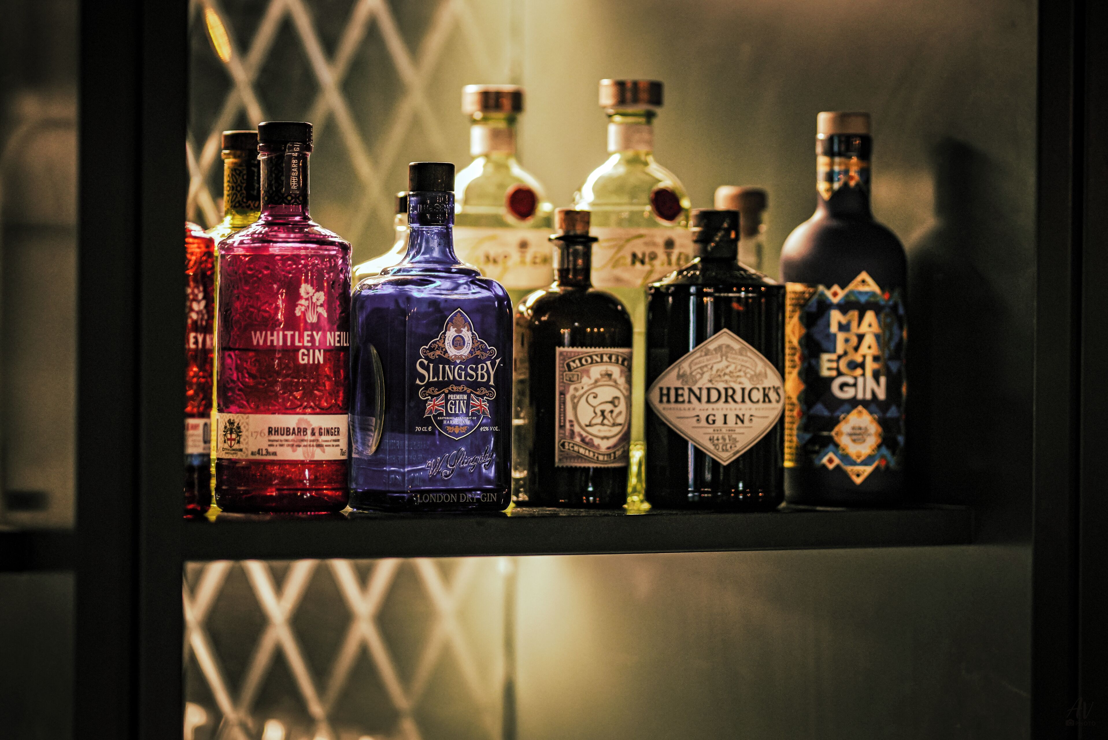 A selection of gin bottles on a shelf.