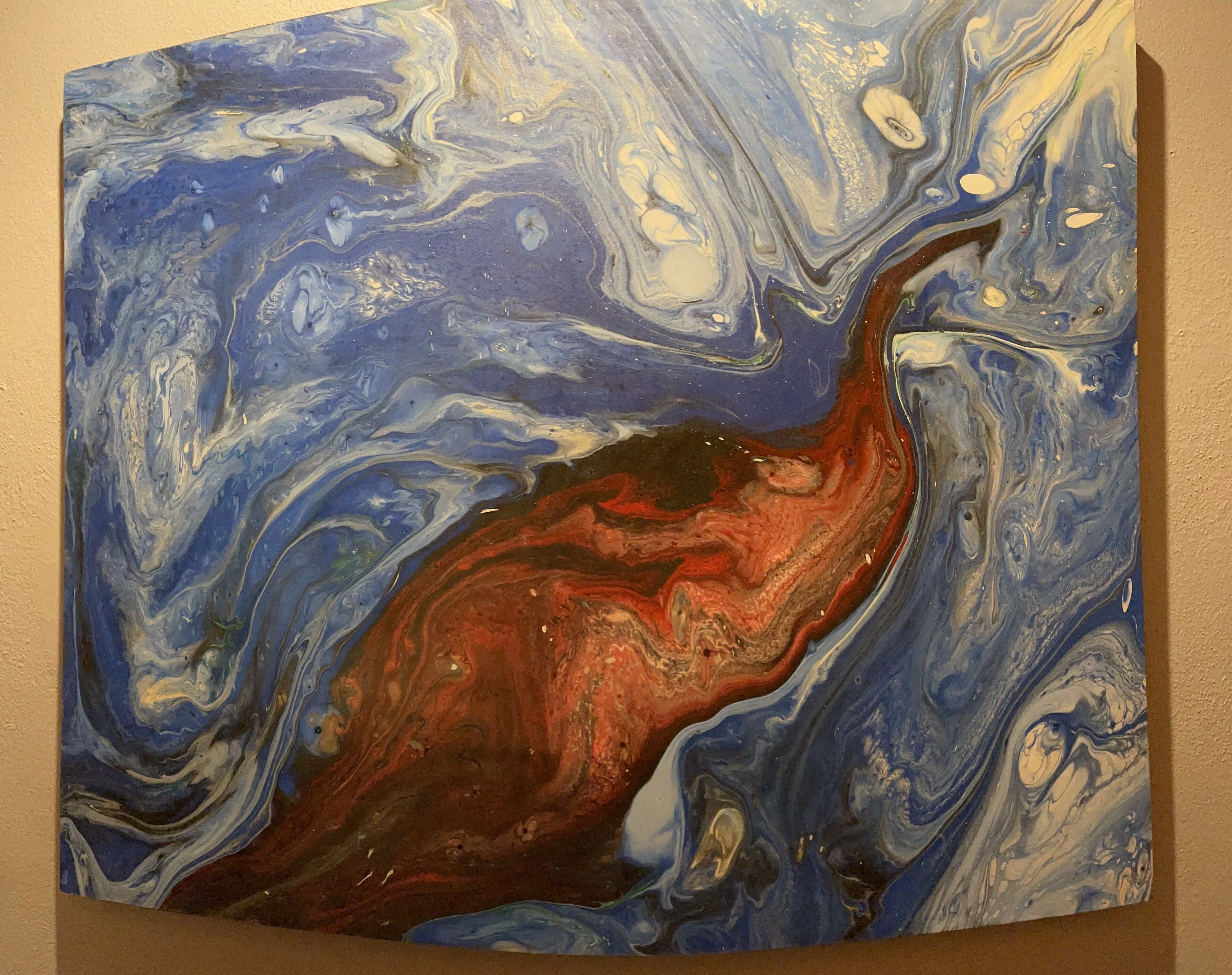 A painting with abstract swirling patterns in blue, white, and red.