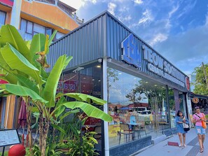 A storefront with a large glass window and a sign reading "COW SOCKS". - Arch Dormitorio Cenang  - Hostel (Langkawi)