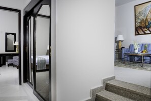 A hotel room with a bed, a desk with a lamp, a chair, and a window. - Safir Dahab Resort (Dahab)