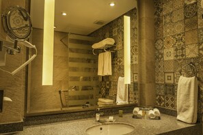 A bathroom with a sink, mirror, towel rack, and shower. - Safir Dahab Resort (Dahab)