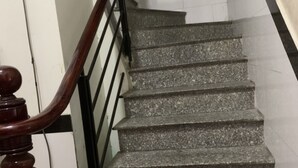 A staircase with granite steps and a wooden handrail. - Gia Bao Hotel (Ho Chi Minh City)