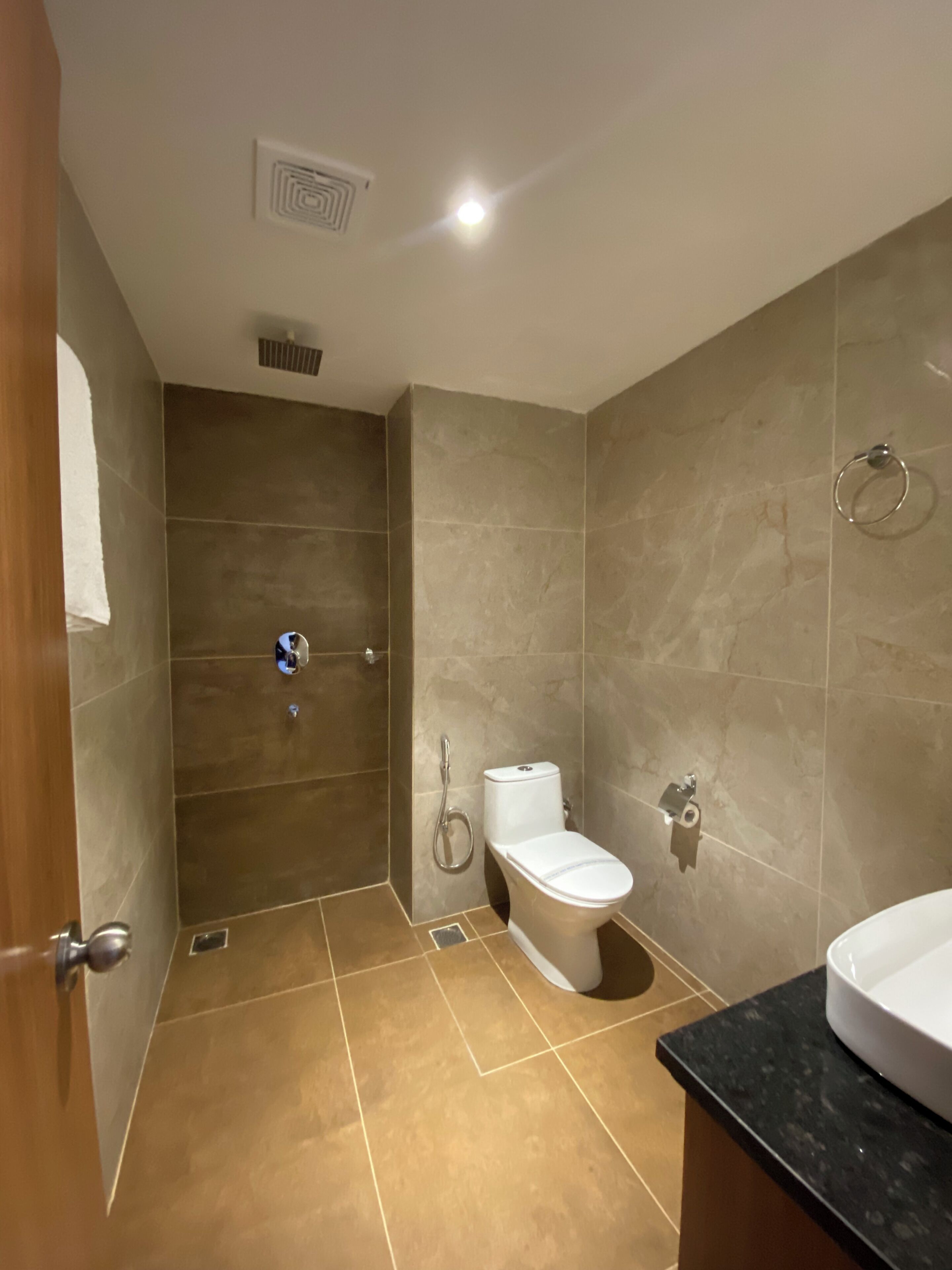 A bathroom with a shower, toilet, and sink.