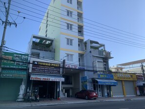 A multi-story building with various businesses, including a hotel and a restaurant. - Italy Hotel (Nam Nha Trang)
