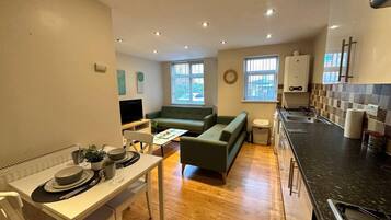 Apartment, 1 Queen Bed | Living area | 30-inch TV with cable channels