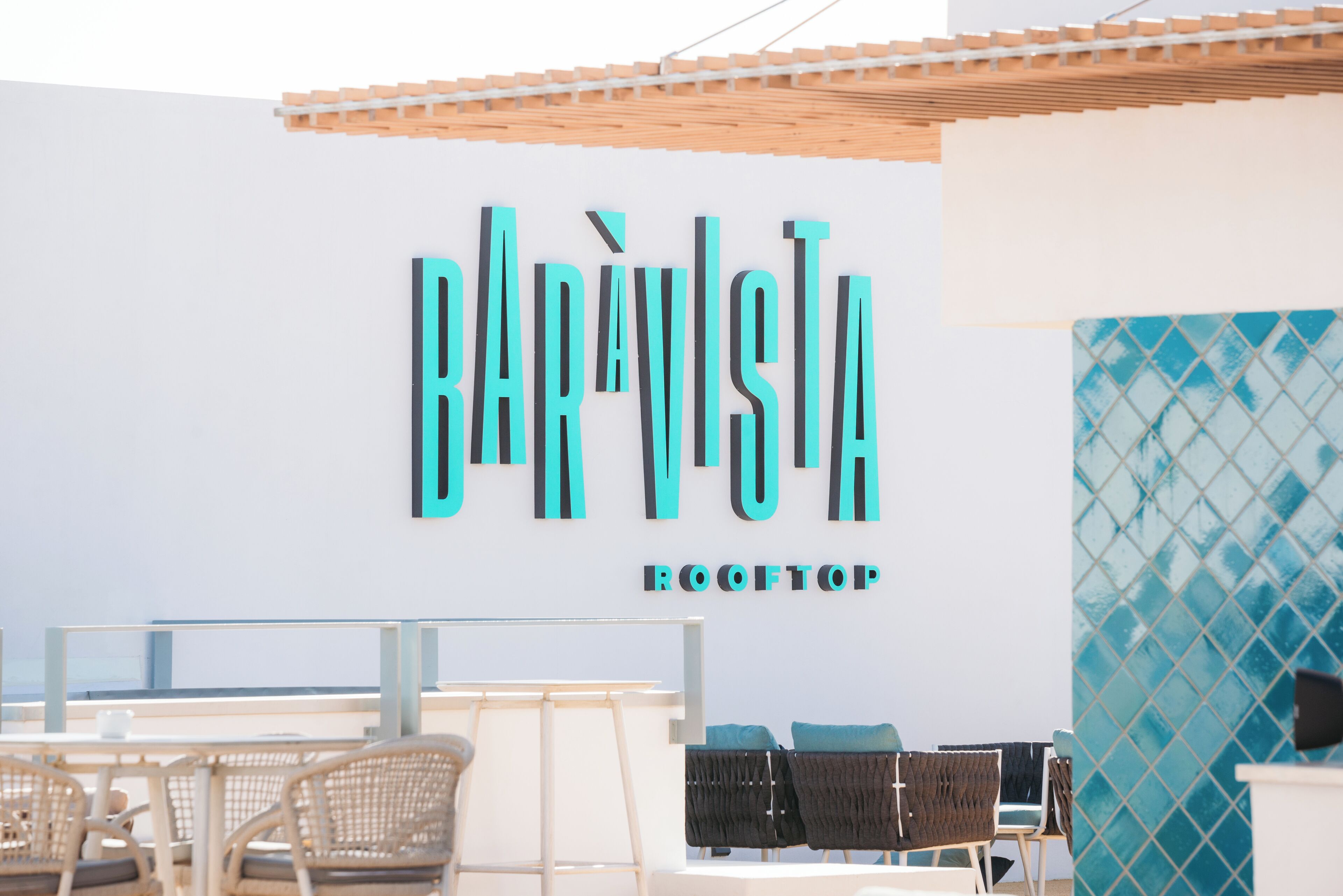 A rooftop bar with a sign that reads "BARISTA ROOFTOP".