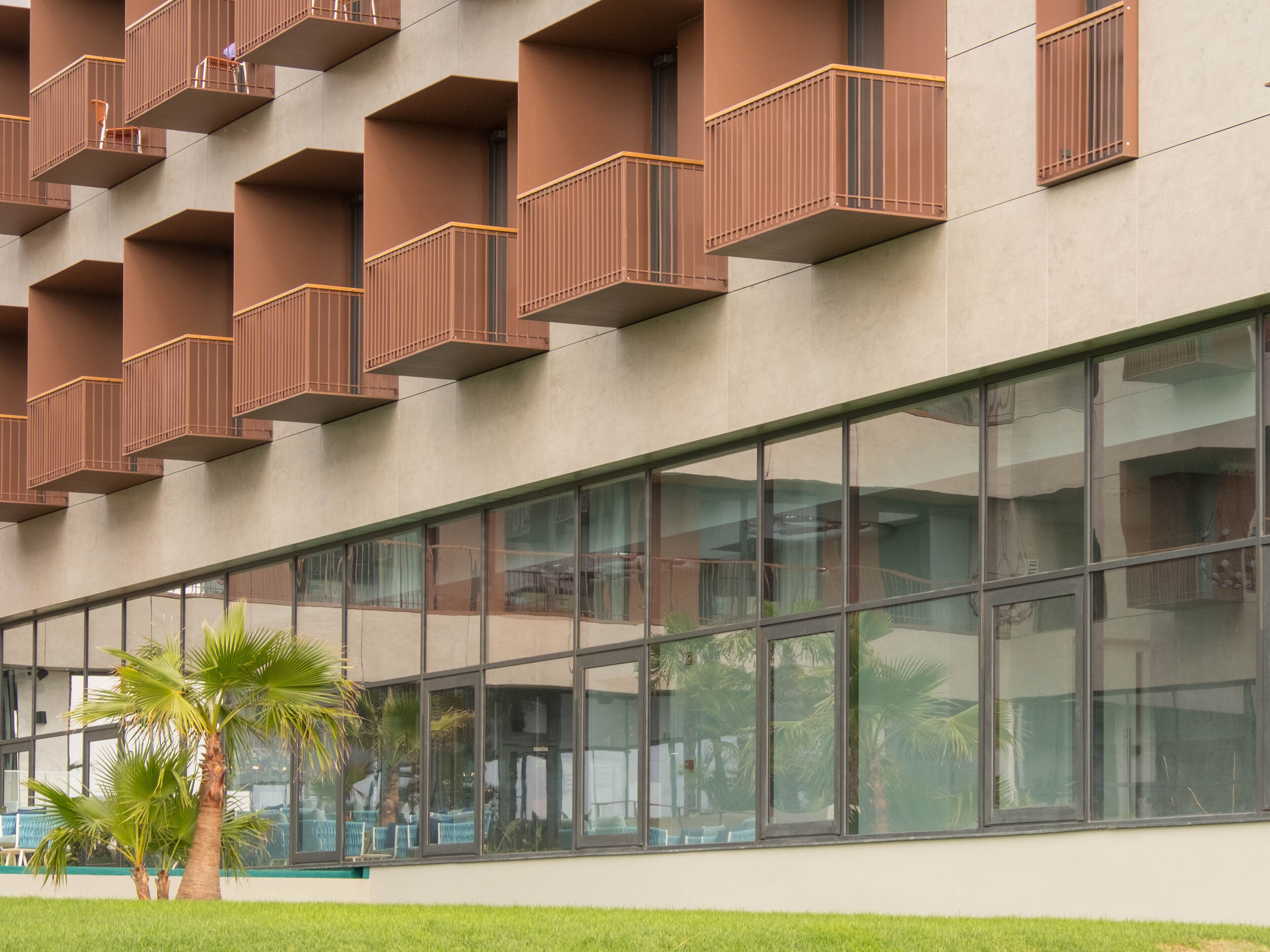 Un edificio moderno con varios balcones y ventanas amplias.