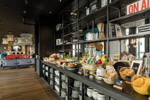 Ein Buffet mit verschiedenen Speisen sowie eine Sitzecke mit einer Couch und Sesseln.