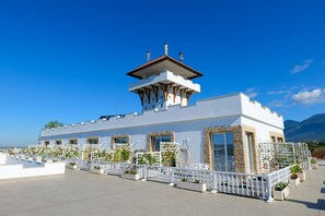 A white building with a tower, large windows, and a white fence. - Nari Lunder Agro-Tourism (Farkë)