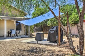 Enjoy al fresco dining in the backyard patio area, complete with a barbecue grill and comfortable seating.