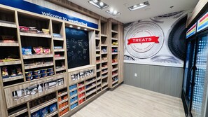 A snack display area with various packaged snacks and a chalkboard menu.