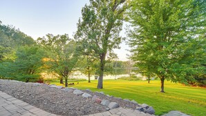 A park with a paved walkway, trees, and a lake. - Patio, Views & Hot Tub: Quiet Lakeside Cabin (Grantsburg)