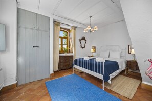 Cozy retreat with a large bed, bedside tables, and a dresser, perfect for a comfortable stay.