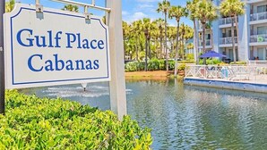 A sign for Gulf Place Cabanas with a water feature and palm trees in the background. - 97 Steps to Beach,  Beautiful Condo, Balcony Sleeps 5 (Santa Rosa Beach)