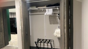 A walk-in closet with a metal rack, shelves, and hanging space. - Colorful Cape Cod (Lexington)