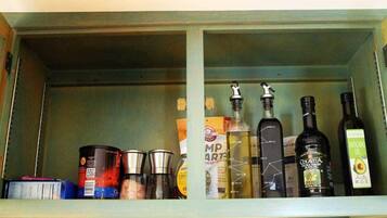 A kitchen cabinet with various food items and bottles.