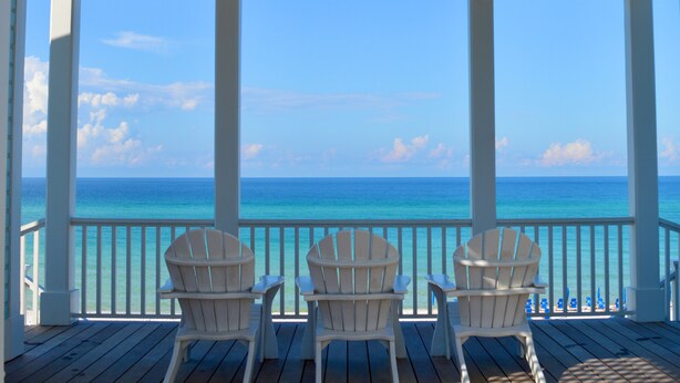 A covered outdoor area with two Adirondack chairs facing a clear blue ocean. - Only 361 Feet to Beach Access in Seaside, King Primary & Renovated + 2 Bikes (Santa Rosa Beach Fl)