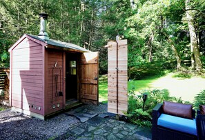 A rustic wooden cabin with a chimney, a door, and a small porch area. - Historic Hudson Valley Farmhouse w/ Sauna in Stone Ridge Hamlet (Stone Ridge)