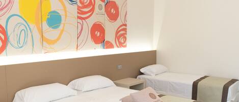 A hotel room with two beds, a large abstract painting on the wall, and a ceiling vent.