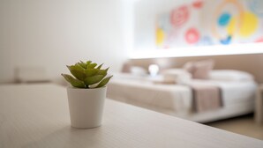A small potted plant on a table in a modern, well-lit room with a minimalist design. - Palazzo San Giovanni (Cava de' Tirreni)
