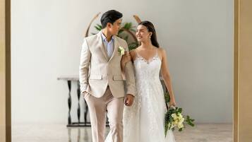 A couple in wedding attire walking together.