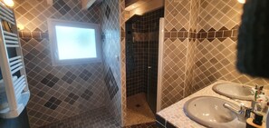 Bathtub, hair dryer, towels, toilet paper