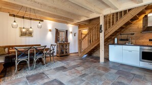 A wooden interior with a dining area, staircase, and kitchen. - 'Chalet Kaisereck' with Terrace & Wi-Fi (Reit im Winkl)