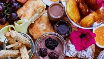 A variety of food items including bread, pastries, and a bowl of berries.