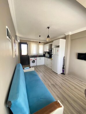 Family Condo, Pool View | Living area | 80-cm flat-screen TV with satellite channels - Oludeniz Evleri (Fethiye)