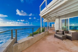 A coastal balcony with outdoor furniture and a view of the ocean. - Oceanfront Beach Villa With Spectacular Views And Large Private Oceanfront Patio (San Diego)