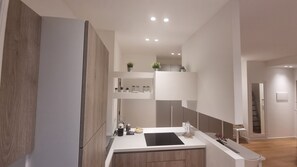 Enjoy cooking and entertaining in this well-lit kitchen with a central island and shelving.