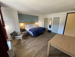 Cozy retreat with a single bed, nightstand, and table, perfect for a relaxing stay.