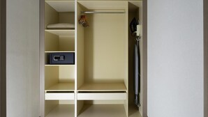 A walk-in closet with multiple shelves, a hanging rod, and a built-in shoe rack.