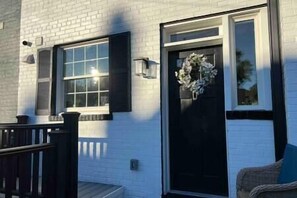 Welcome to a charming home with a cozy porch and a beautifully appointed entrance.