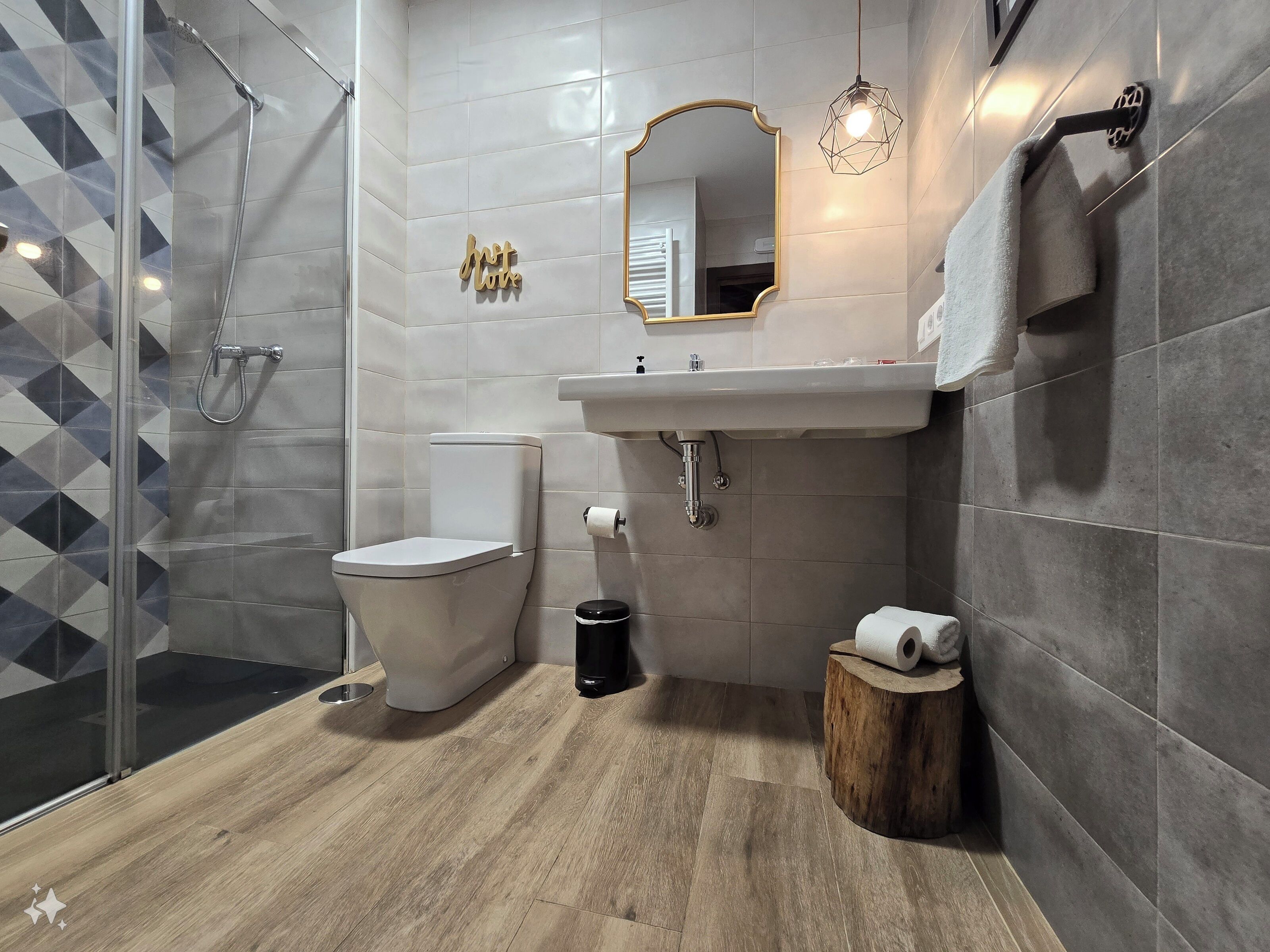 A modern bathroom with a toilet, sink, and shower.