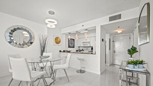 A modern kitchen with white cabinets, a built-in microwave, and a stainless steel sink. - The Club 3305 · *High Floor Superb Unit In the Heart Of Brickell* (Miami)
