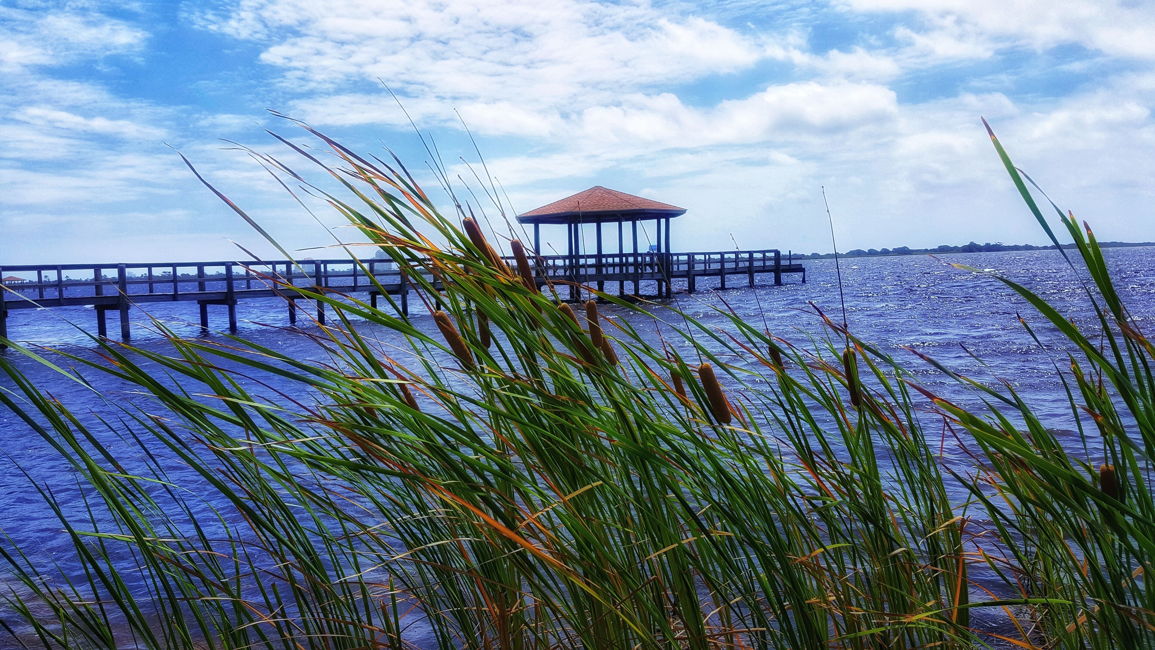 A pier extending into the water with a gazebo at the end.