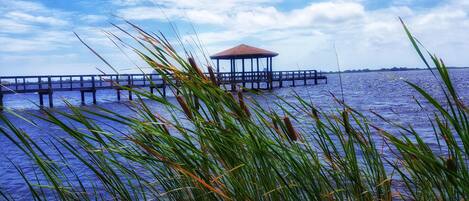 A pier extending into the water with a gazebo at the end.
