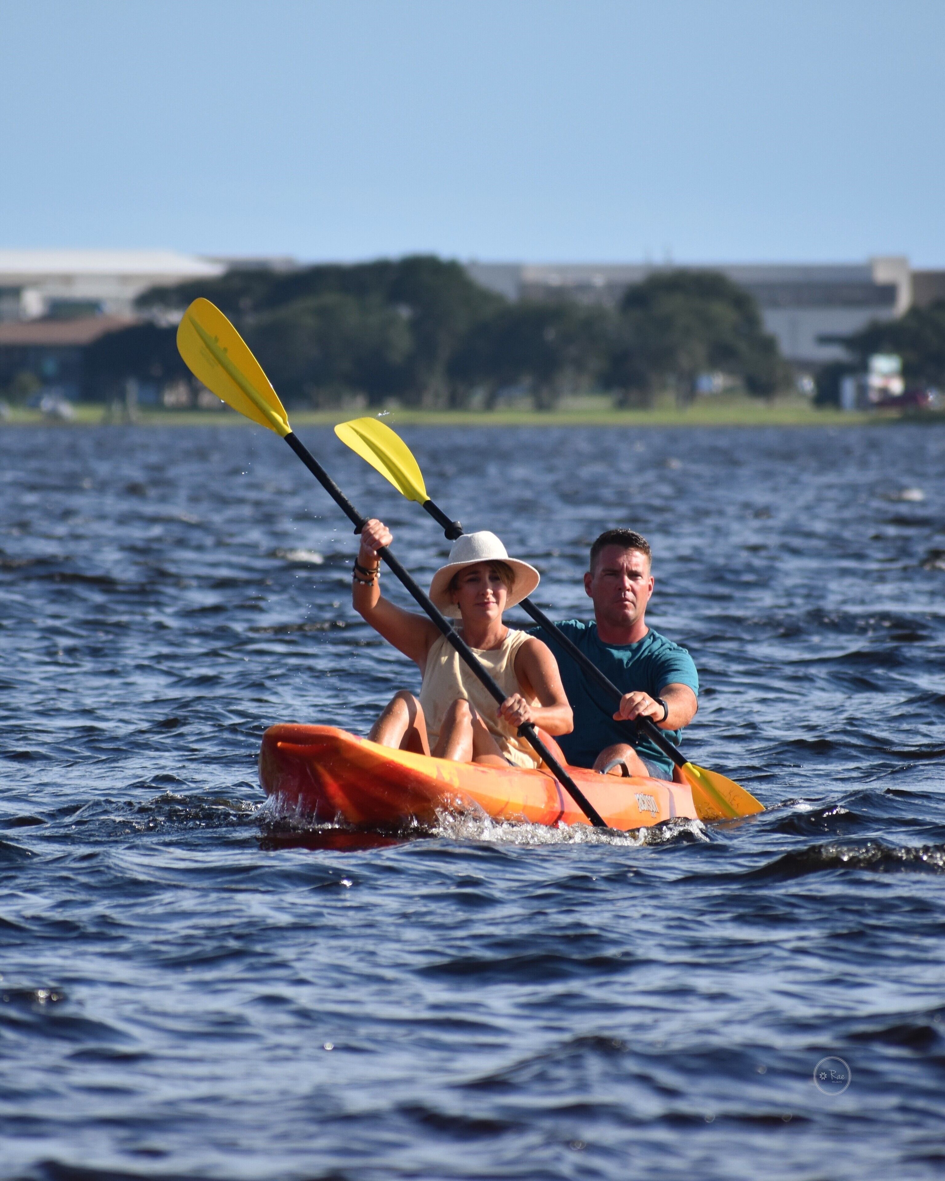 Two people in a kayak on a body of water.