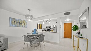 A modern kitchen with white cabinets, stainless steel appliances, and a central island. - Splendid Unit with Parking in Brickell Miami (Miami)