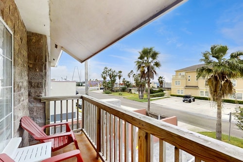 Second-floor condo 1/2 block from the beach with pool, central AC & W/D