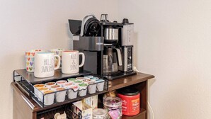 A coffee station with a Keurig machine, coffee mugs, and a mug holder with heart designs. - Texas Two Step - welcoming getaway at the steps of Sea World, near BMT! (San Antonio)