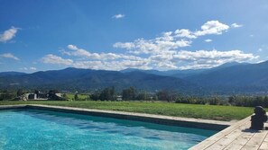 Relax by the serene pool overlooking the majestic mountains.