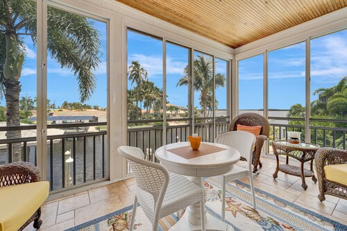 Waterfront home with private pool, dock, patio, balconies, & bikes