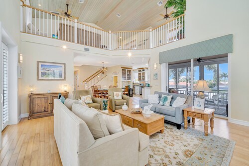 Waterfront home with private pool, dock, patio, balconies, & bikes