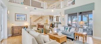 Waterfront home with private pool, dock, patio, balconies, & bikes