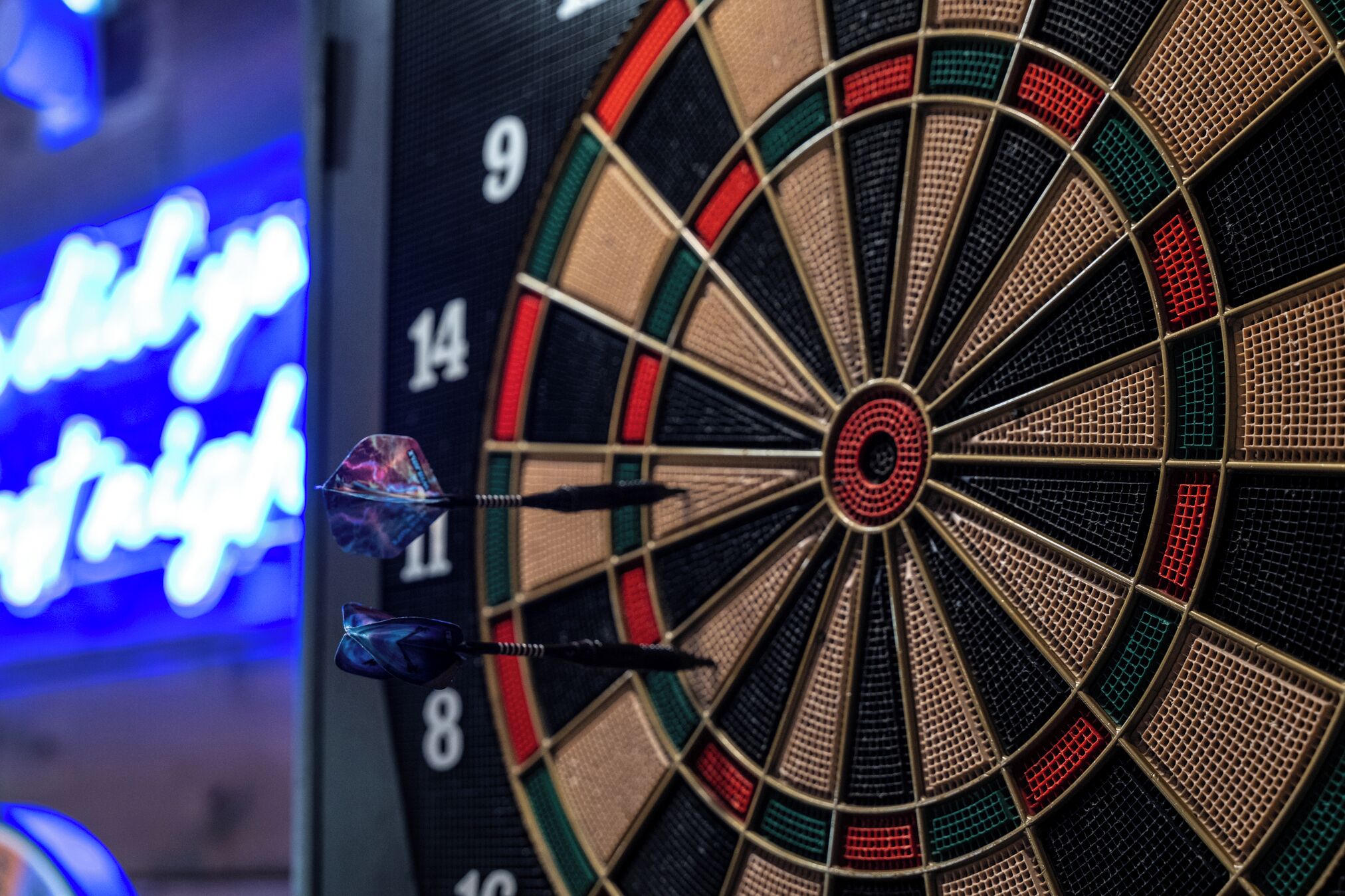 A dartboard with three darts in the center.