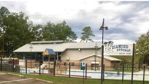 A building labeled 'Diamond Springs Water Park' with a fenced swimming pool area. - Robins Nest "The Best Nest In Town"  Newly Remodeled Master Bath. (Murfreesboro)
