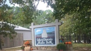 A sign for Gator of Diamonds State Park with a stone base and a painting of a gator. - Robins Nest "The Best Nest In Town"  Newly Remodeled Master Bath. (Murfreesboro)