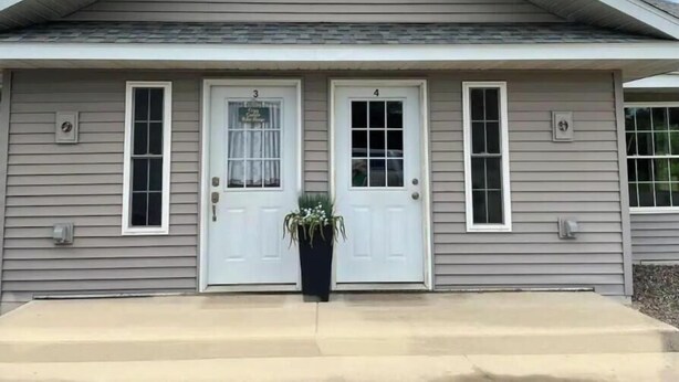 A two-story house with a gabled roof and a front porch. - Sweet Escape, next to C-I bike/snowmobile trail. (Crosby)